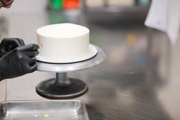 istock pastry chef designer decorating frosted cup cake with multi colored polka dots 1439626668