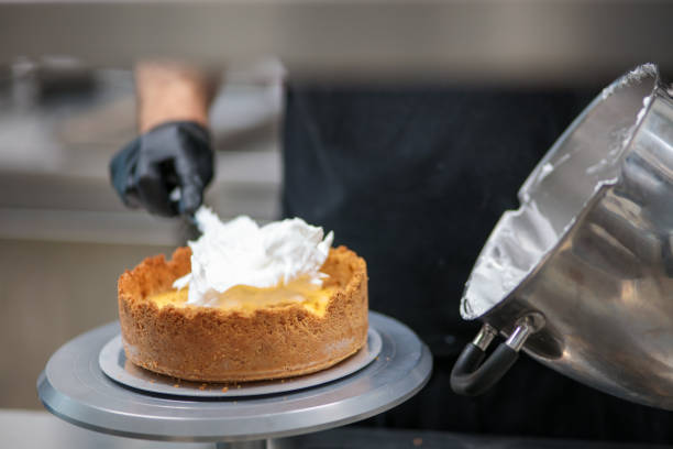 istock pastry chef designer filling a pie crust with lime flavour meringue with spatula 1439626714