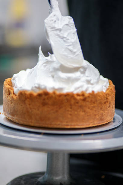 istock pastry chef designer filling a pie crust with lime flavour meringue with spatula 1439626725