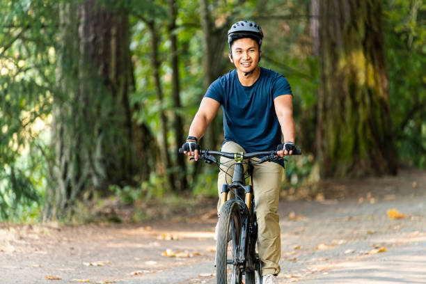 istock Man Riding Bike on Path at Park 1439634499