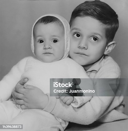 istock Black and white photo from the sixties, a little boy and a little girl posing together 1439638873