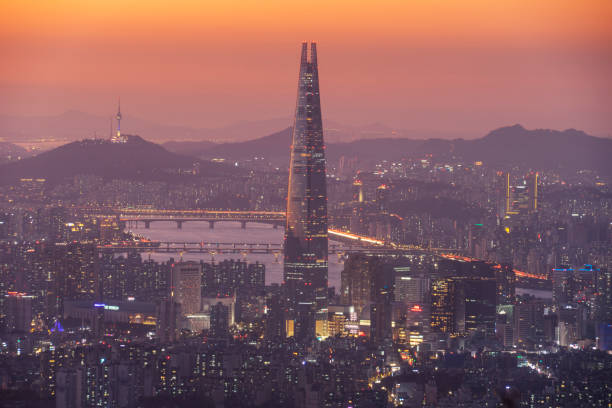 Seoul skyline with Lotte Tower at sunset Seoul skyline, seen from Namhansanseong at sunset with local landmarks like the Lotte Tower in the middle and the Han River and Namsan Tower in the background on the left. Lotte World Tower