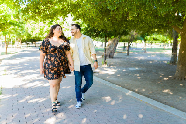 istock Happy couple taking a walk on the park while on a date 1439643683