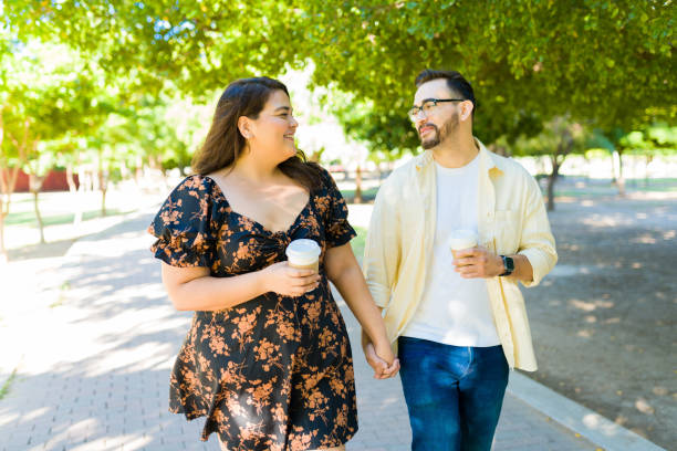 istock Romantic couple holding hands at the park 1439643689