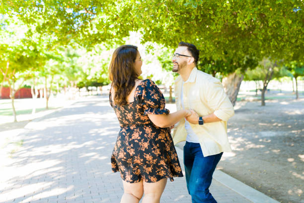 istock Happy couple having fun while on a date at the park 1439643784