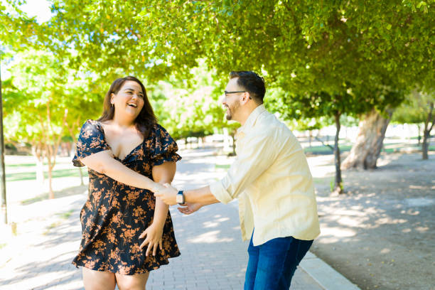 Happy couple dancing a romantic song at the park