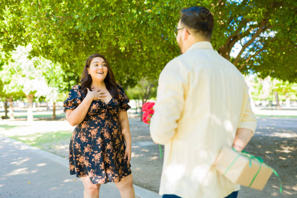 istock Boyfriend bringing flowers for his date 1439643842