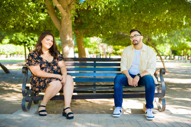 istock Attractive couple relaxing at the park 1439644526