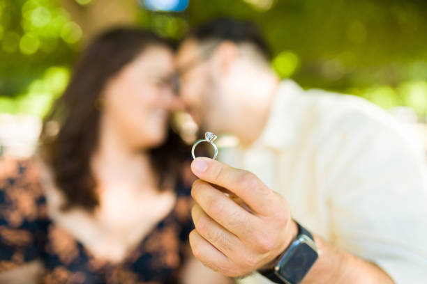 istock Engaged couple in love showing their engagement ring 1439644575