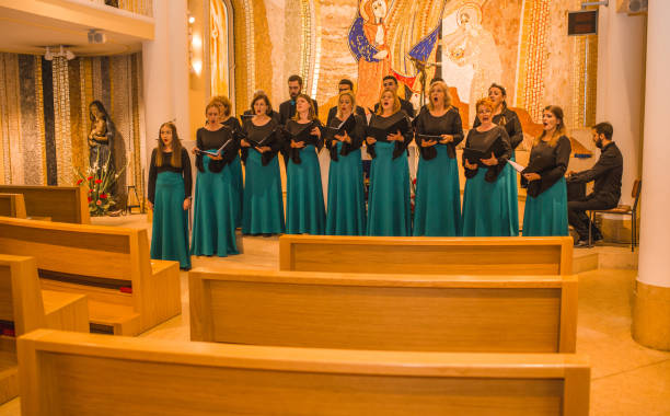 istock Choir practice before the concert, while their conductor plays the piano 1439647465