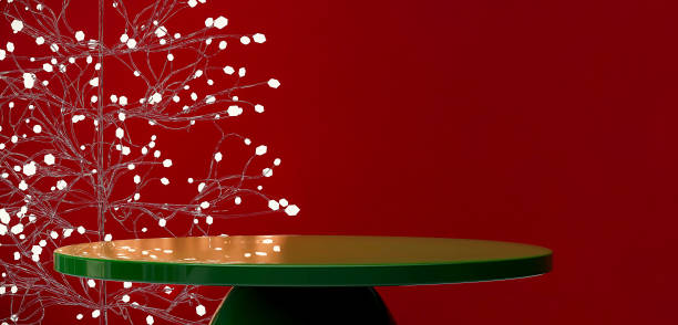 Modern and luxury green glossy round podium with white string lights glass Christmas tree in red background for Christmas celebration and product display concept