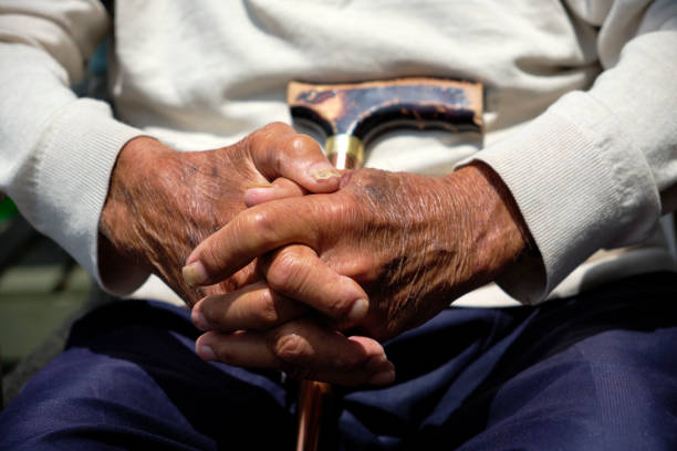 istock Senior man with hands clasped. Dark skin toned hands 1439648456