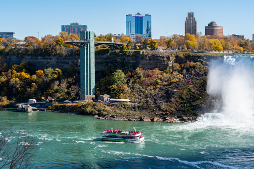 Niagara Falls City, Ontario, Canada - October 27 2022 : Maid of the Mist USA Boat Tour. Niagara Falls Observation Tower. American Falls. Autumn foliage season.