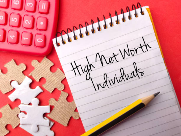 Calculator,puzzle And Pencil With Text High Net Worth Individuals On Red Background