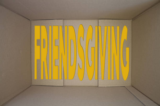 Friendsgiving word with cardboard box. Brown folded card box.