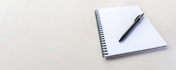 istock Banner with copy space. Notebook on a spiral on a plain beige background. 1439654164