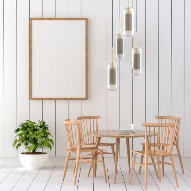 istock Picture frame attached to the wall, with chairs and vases placed on the table. 1439654833