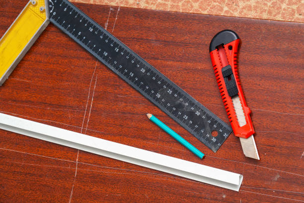 istock Construction or stationery knife, pencil and ruler on the board 1439655703