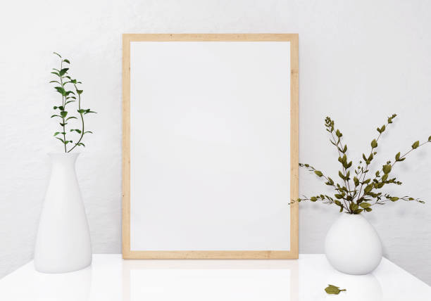 A picture frame on the floor with a flower vase. stock photo