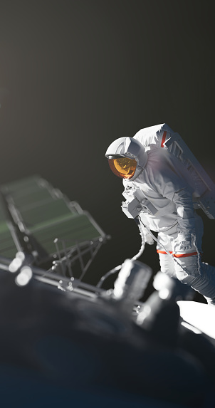 An astronaut in a mysterious light working in the outer space, we see a spaceship or satellite next to him