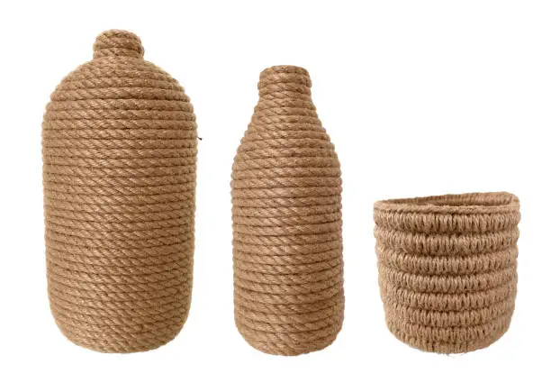 Pots wrapped and basket knitted from jute thread isolated on white background. Rough handicrafts in rustic style. handmade scandi set