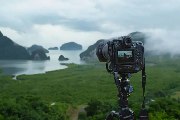 Mirrorless camera on tripod taking timelapse video of Samet Nangshe scenic point on cloudy day