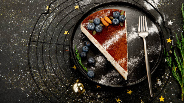 istock Christmas cake slice on dark background. 1439660669