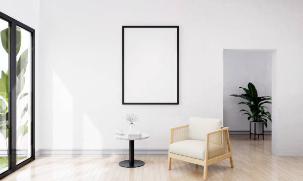 istock Picture frame attached to the wall, with chairs and vases placed on the table. 1439660674