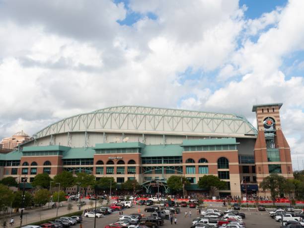 Line of Astros Fans Waiting to Enter the Team Store at Minute Maid Stadium in Houston after the World Series Win Line of Astros Fans Waiting to Enter the Team Store at Minute Maid Stadium in Houston after the World Series Win with clouds above and a parking lot in the foreground. houston astros stock pictures, royalty-free photos & images
