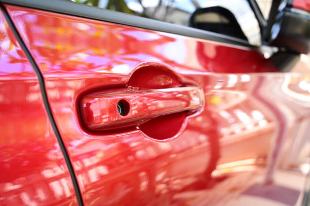 istock door handle of red car, transpotation industry 1439661888