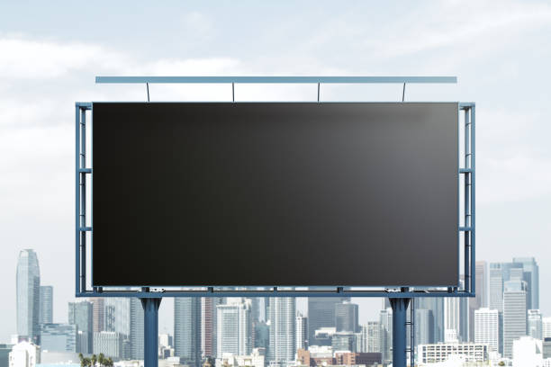 Blank black horizontal billboard on skyline background, front view. Mock up, advertising concept stock photo