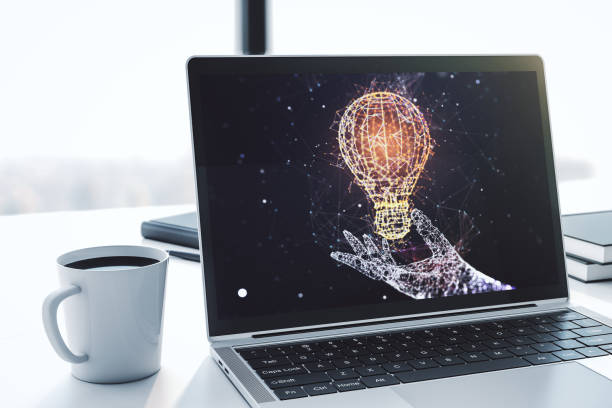 istock Modern computer monitor with creative light bulb hologram, research and development concept. 3D Rendering 1439667340