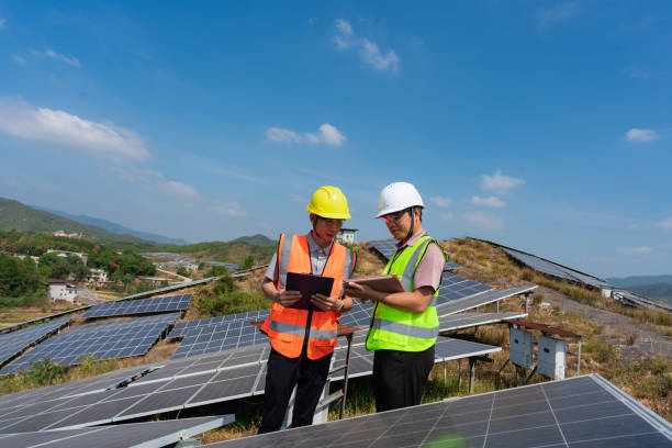 istock Two power engineers communicate and discuss at solar power plant 1439668392