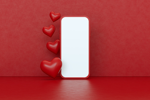 Valentine's Day Concept Online Shopping Blank Screen Smart Phone with Hearts. Red Background.