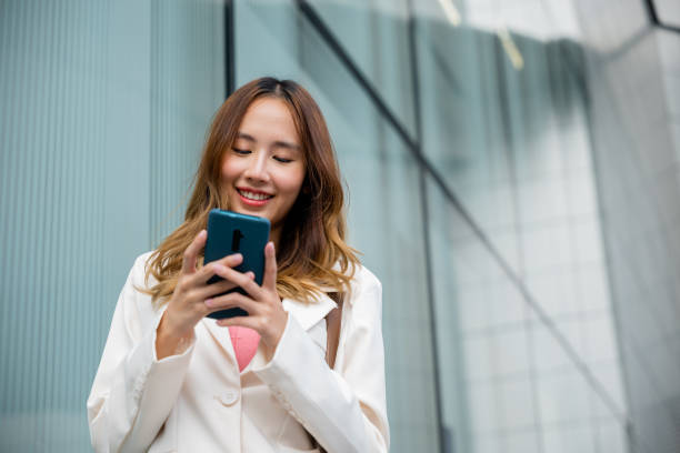 istock Asian businesswoman texting smartphone commuting work 1439668645