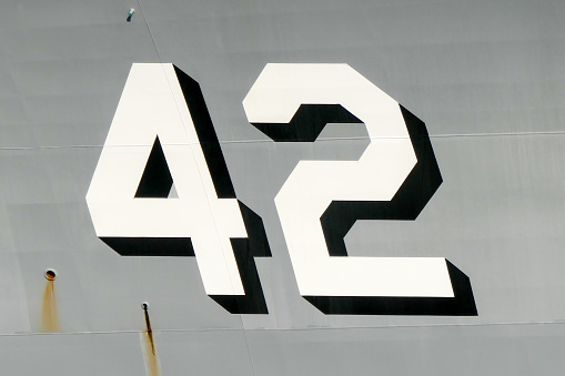 Bow of HMAS Sydney, a destroyer of the Royal Australian Navy with her ship number.  She is moored at Garden Island, Sydney Harbour.  This image was taken on an afternoon in Spring.