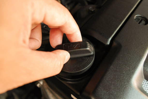 istock The auto mechanic is opening the oil cap 1439669743