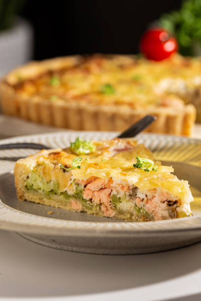istock Dinner with fresh homemade pie with salmon fish and broccoli, quiche 1439669840