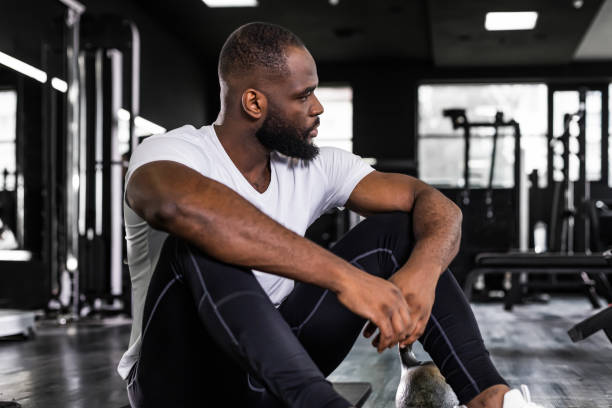 istock Sporty african man resting, having break after doing exercise. 1439670845