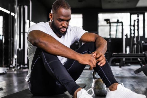 istock Sporty african man resting, having break after doing exercise. 1439673012