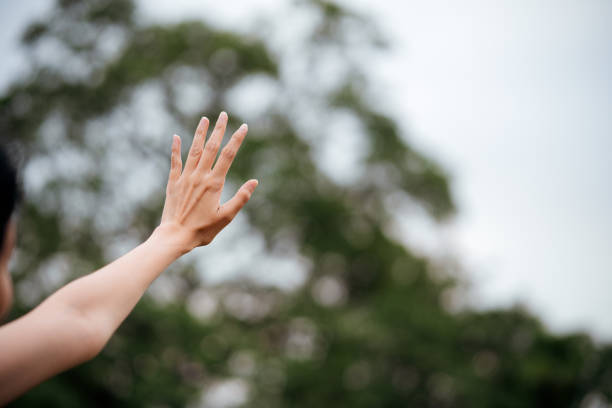 istock Asian woman hand touching the sky 1439673096