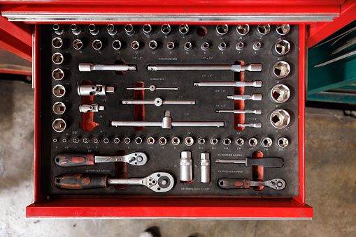 car service tools in tray of the red steel suitcase. Mechanic, equipment in garage Concept. topview.