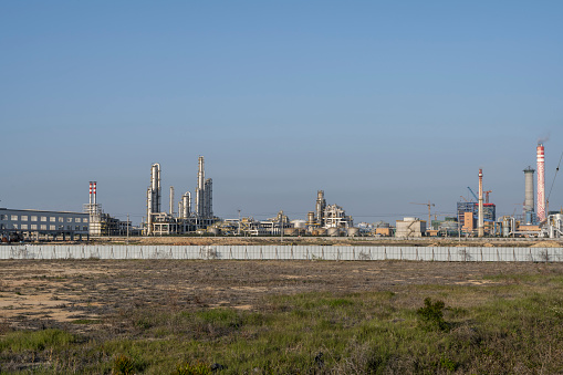 bio power plant with storage of wooden fuel (biomass) against blue sky