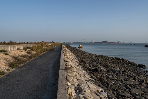 Roads along the coast and chemical plants in the distance