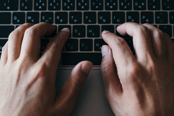 istock An overhead view of hands typing on a laptop 1439676850