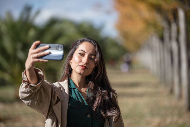 istock Young girl is taking a selfie in nature. 1439677740
