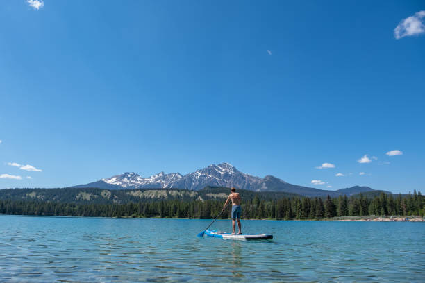 istock Woman Paddle boarding on a pristine lake 1439680728