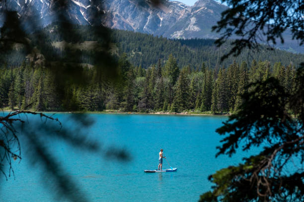 istock Woman Paddle boarding on a pristine lake 1439680762