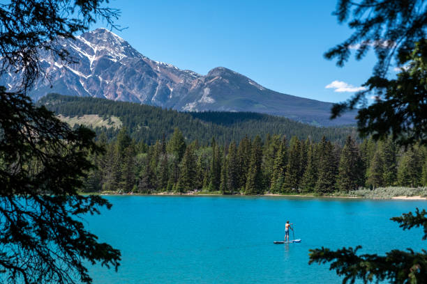 istock Woman Paddle boarding on a pristine lake 1439680774