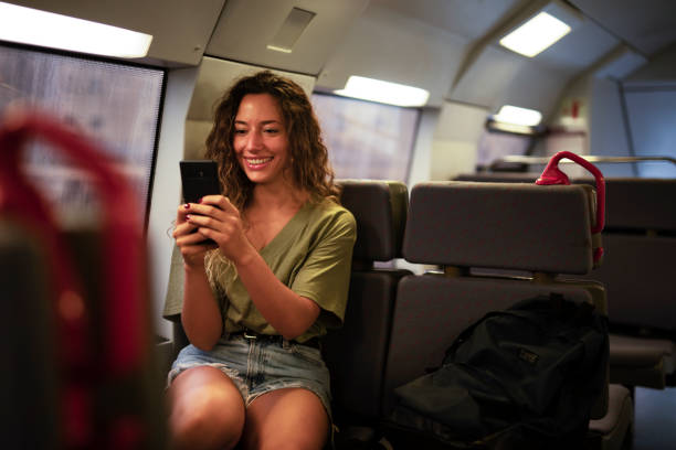 istock Happy smiling woman using the phone while travel by train 1439681395